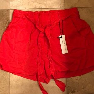 Coral beach shorts. Size medium, never worn